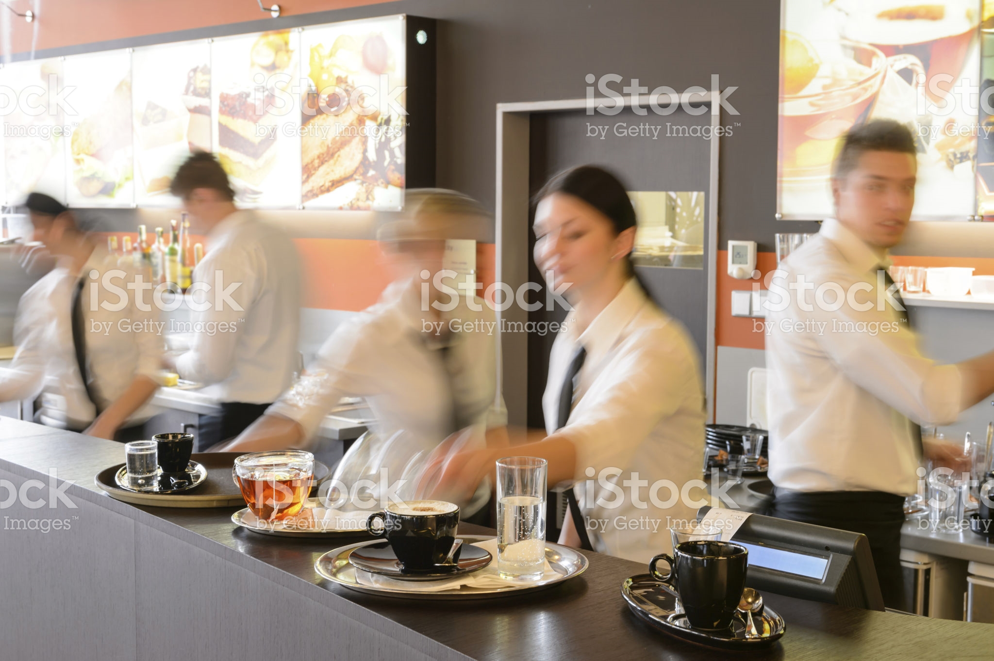 busy-waiter-and-waitresses-working-at-bar-picture-id177853320